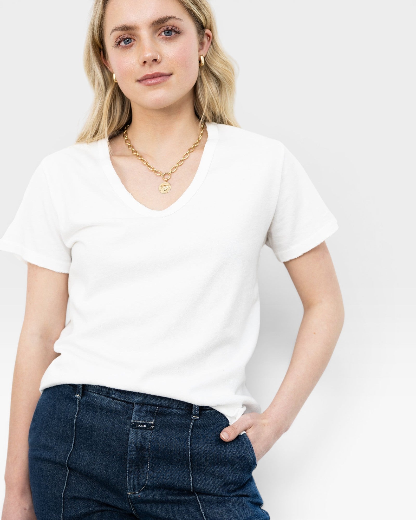 JONES + CO 14K gold chunky square tube hoop earrings worn by a woman with blonde hair.