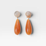 JONES + CO Pamploma earrings with cream spherical studs and orange tear-shaped acrylic drops.
