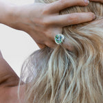 JONES + CO sterling silver statement ring featuring a unique iridescent blue abalone shell stone worn on a finger.