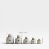 JONES + CO alabaster stoneware stash jars with chunky knobs, shown in 5 sizes from 4" to 10".