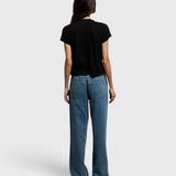 JONES + CO Alanis V Neck tee in true black recycled cotton, shown from the back with blue denim jeans.