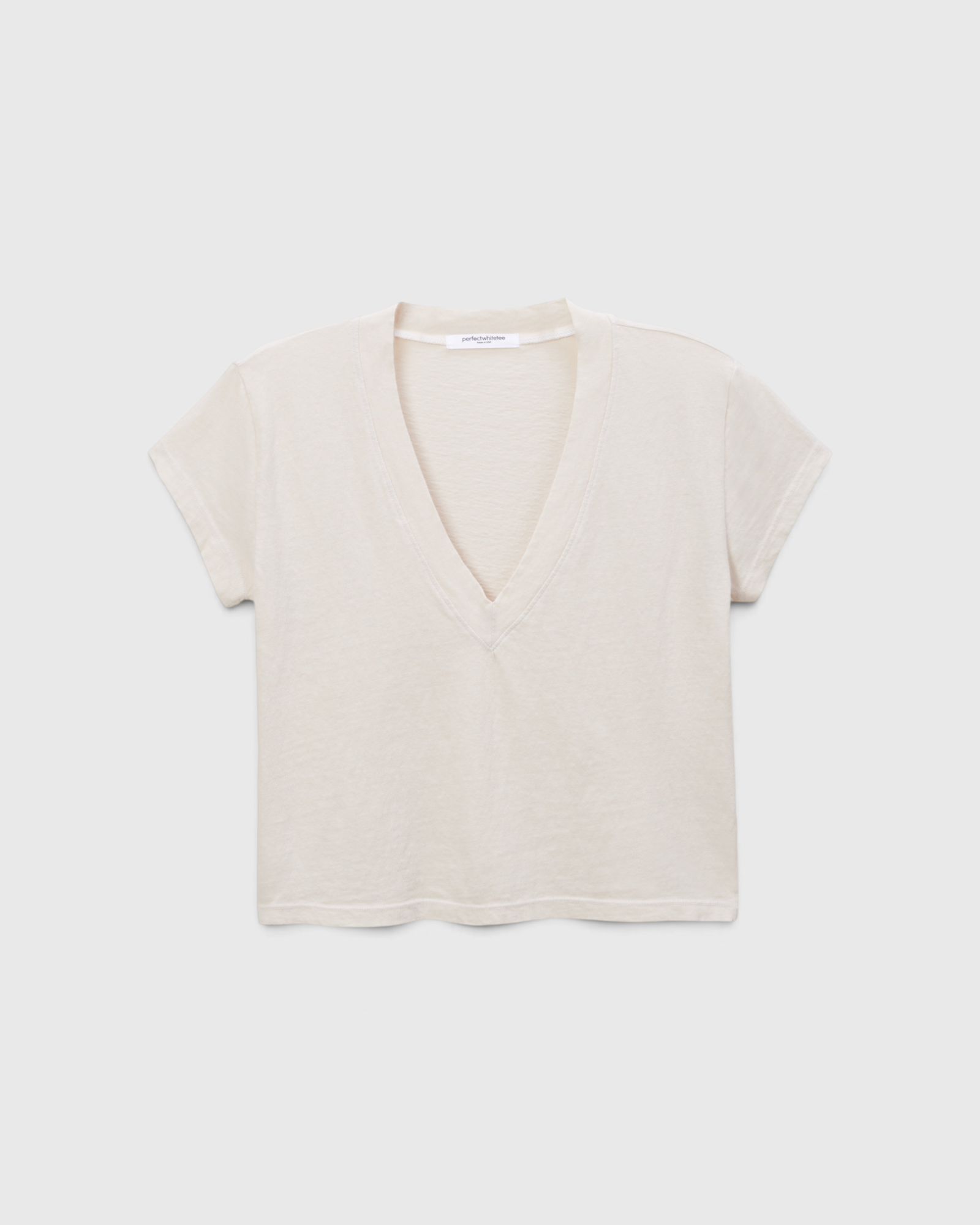 JONES + CO Alanis V Neck tee in sugar off-white recycled cotton with a relaxed cropped fit and deep neckline.