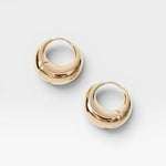 JONES + CO Alpha Hoop small chunky tapered huggie earrings in 12k gold-plated brass with hinge detail.