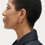JONES + CO Alpha Hoop small chunky tapered huggie earrings in 12k gold-plated brass with hinge detail.