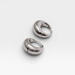 JONES + CO Alpha Hoop small chunky tapered huggie earrings in silver-plated brass with hinge detail.