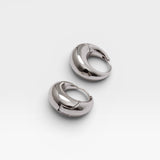 JONES + CO Alpha Hoop small chunky tapered huggie earrings in silver-plated brass with hinge detail.