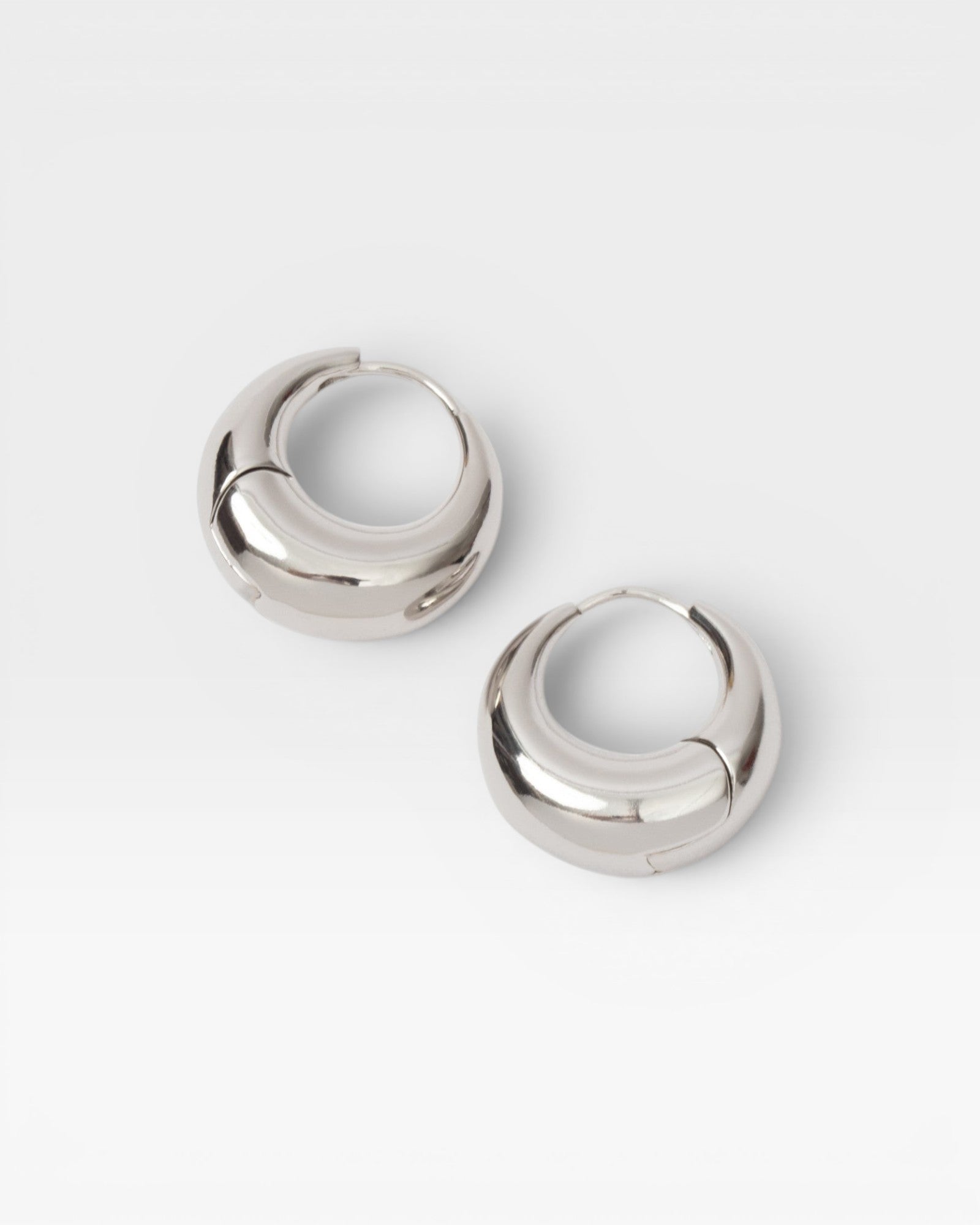 JONES + CO Alpha Hoop small chunky tapered huggie earrings in sterling silver-plated brass with hinge detail.