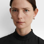 JONES + CO Alpha Hoop small chunky tapered huggie earrings in sterling silver-plated brass with hinge detail.