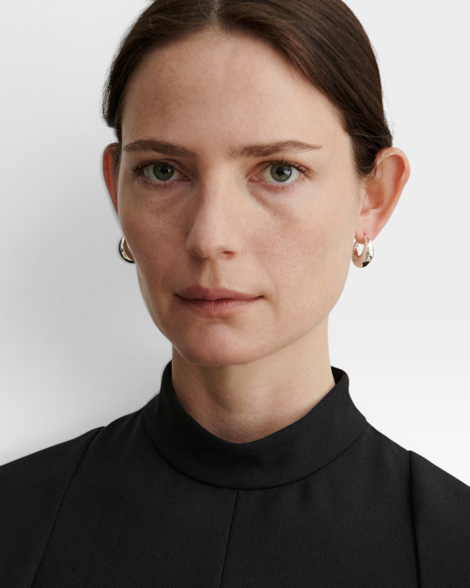 JONES + CO Alpha Hoop small chunky tapered huggie earrings in sterling silver-plated brass with hinge detail.