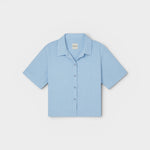 JONES + CO Anais Linen Shirt in baby blue. Short-sleeve, button-down with a relaxed fit and minimalist collar.