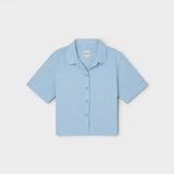 JONES + CO Anais Linen Shirt in baby blue. Short-sleeve, button-down with a relaxed fit and minimalist collar.