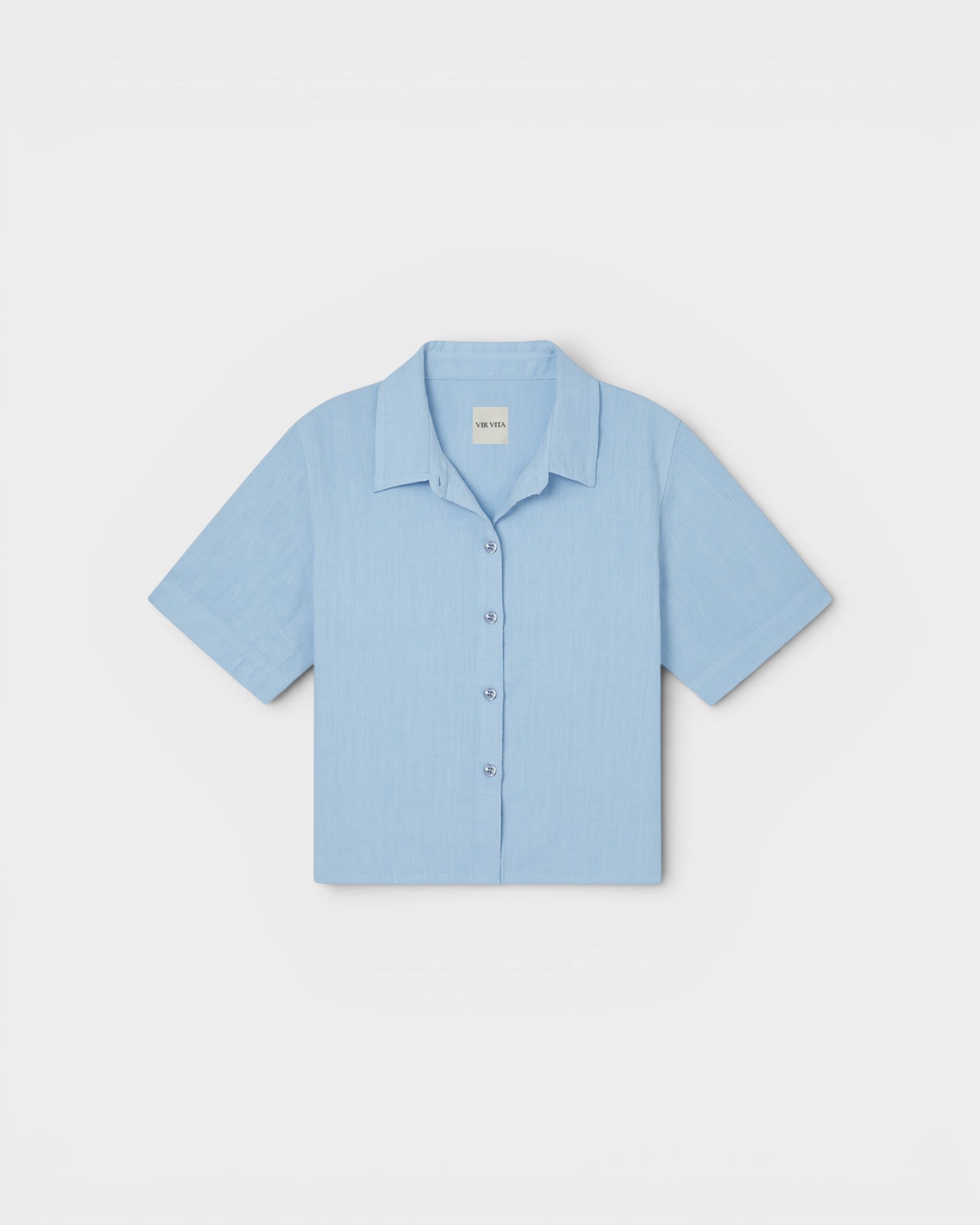 JONES + CO Anais Linen Shirt in baby blue. Short-sleeve, button-down with a relaxed fit and minimalist collar.