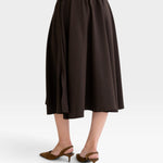 JONES + CO Angie skirt in chocolate brown with an elastic drawstring waistband and side slits, back view