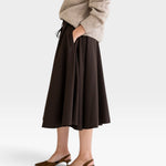 JONES + CO Angie Skirt in chocolate brown featuring side pockets, drawstring waist, and side slits on a model
