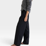 JONES + CO Joanna wool trousers in anthracite with a relaxed wide-leg fit and elastic waistband on a model