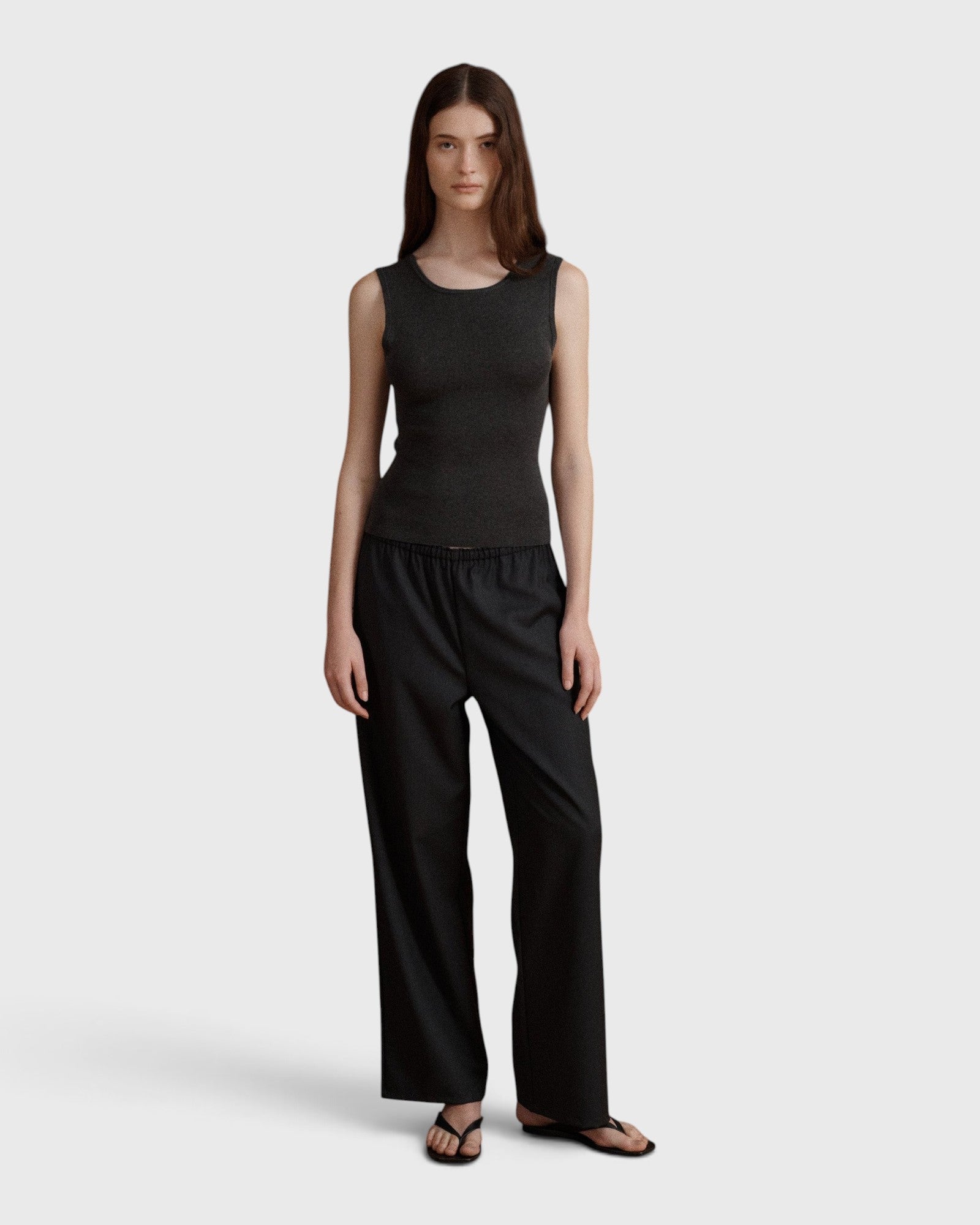 JONES + CO Joanna wool trousers in anthracite with a relaxed wide leg and elastic waistband worn by a model