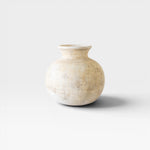 JONES + CO antique clay water pot with a rounded silhouette and weathered patina, neutral beige color.