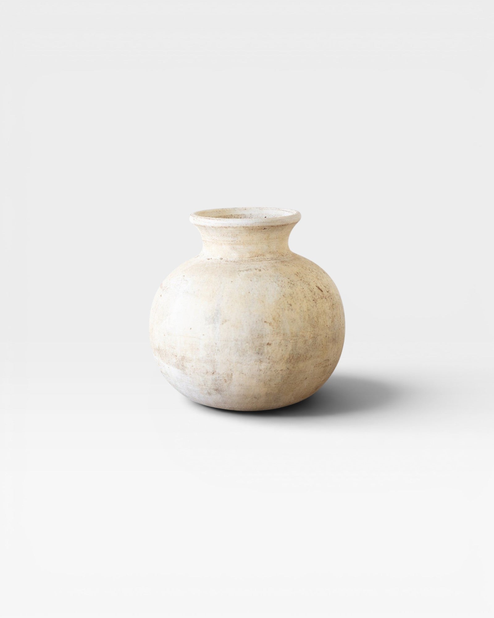 JONES + CO antique clay water pot with a rounded silhouette and weathered patina, neutral tones, 12" H x 10" W