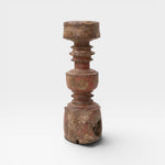 JONES + CO antique rustic wooden pillar with red paint accents and carved details, used as sculptural accent or candle holder.