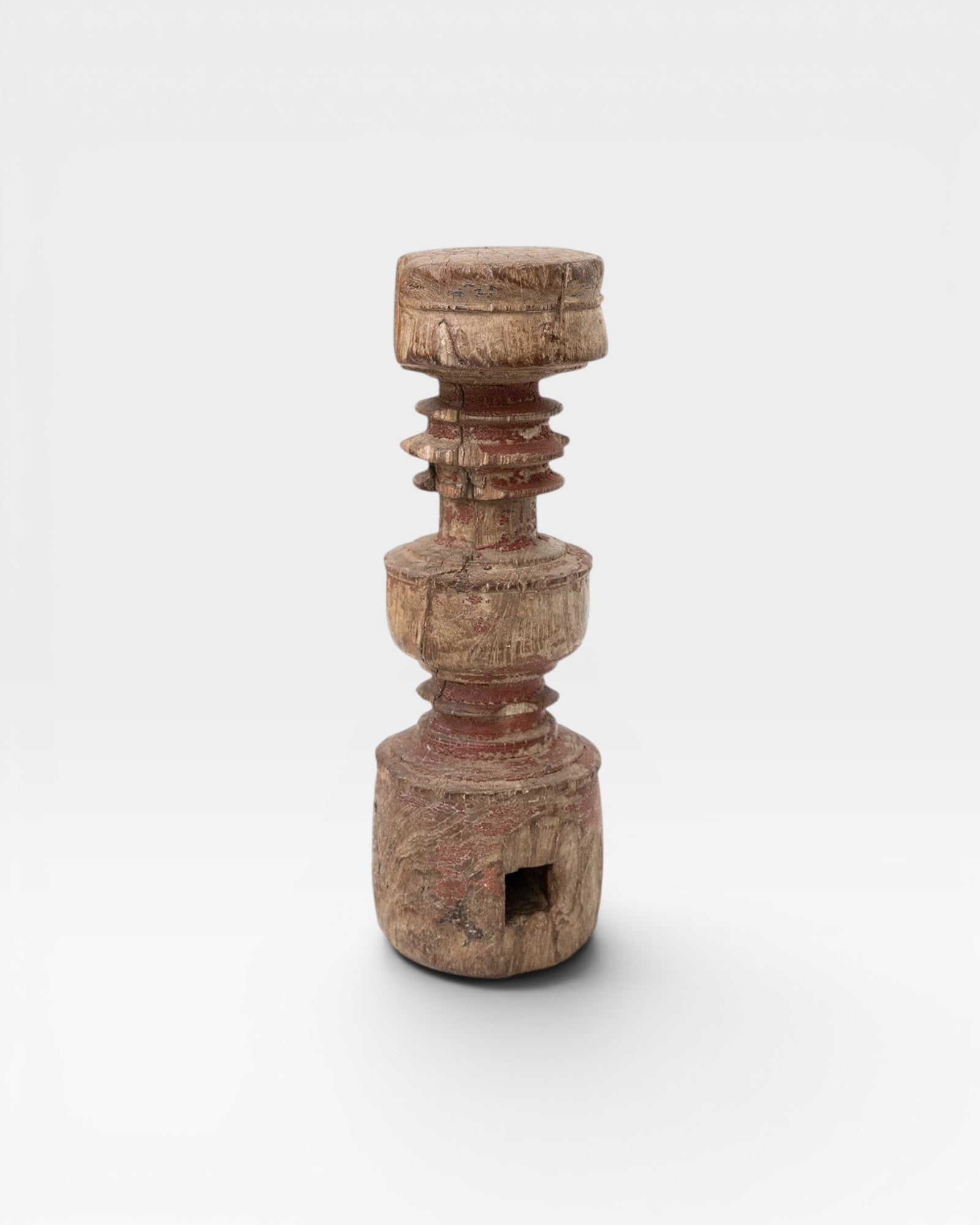 JONES + CO antique rustic wooden pillar with red paint accents and carved details, perfect as a sculptural accent or candle holder.