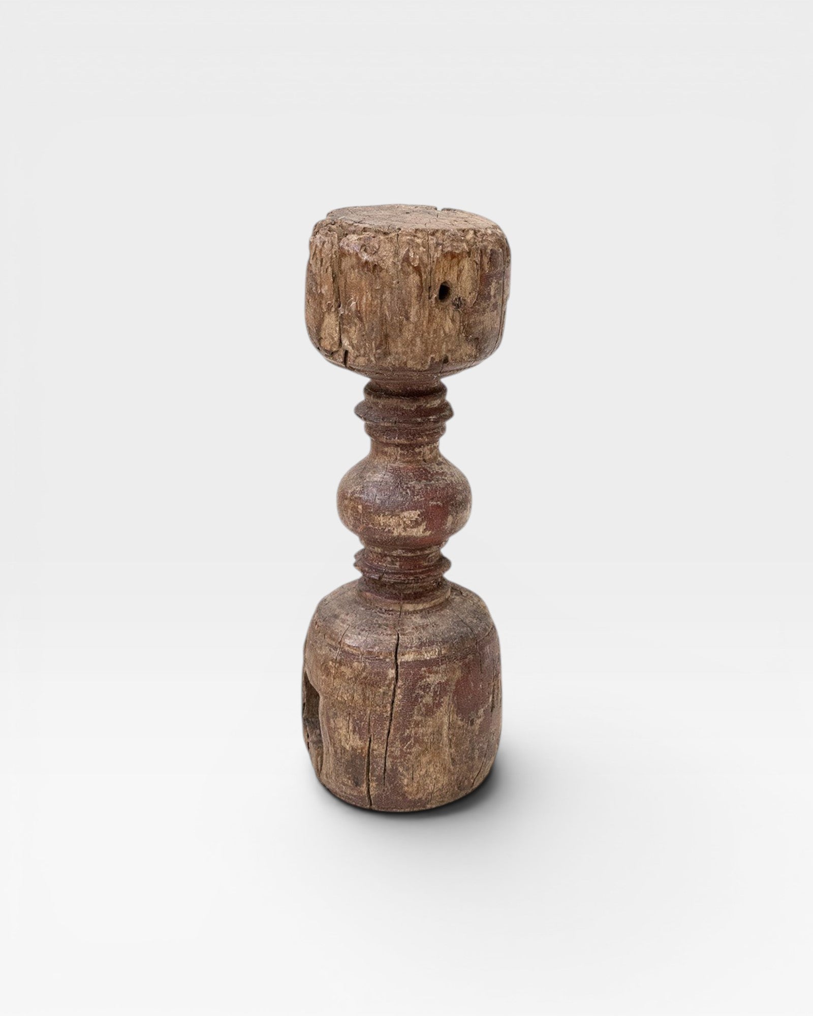 JONES + CO antique rustic wooden pillar with red paint traces and timeworn patina, used as sculptural accent or candle holder.