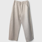 JONES + CO Arc pants in naturel heavy-weight canvas with an elastic high waist, curved leg, and side pockets.