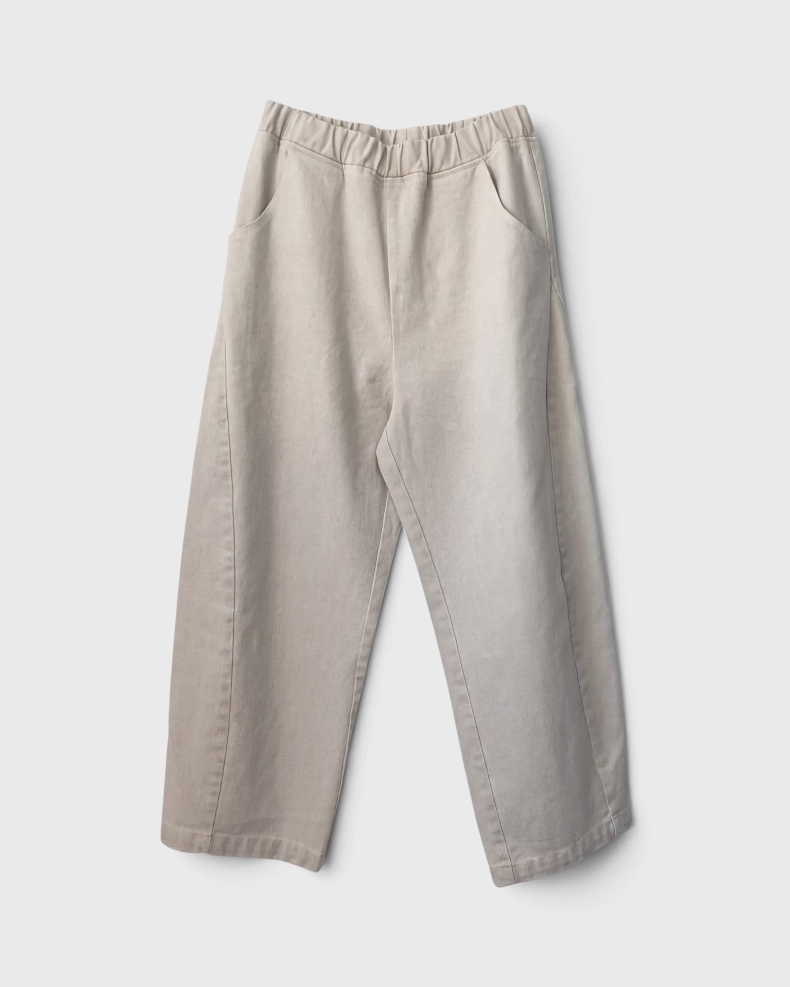 JONES + CO Arc pants in naturel heavy-weight canvas with an elastic high waist, curved leg, and side pockets.
