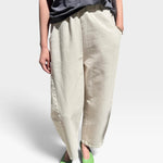 JONES + CO Arc pants in naturel heavy-weight canvas with an elastic high waist, curved leg, and side panel details.