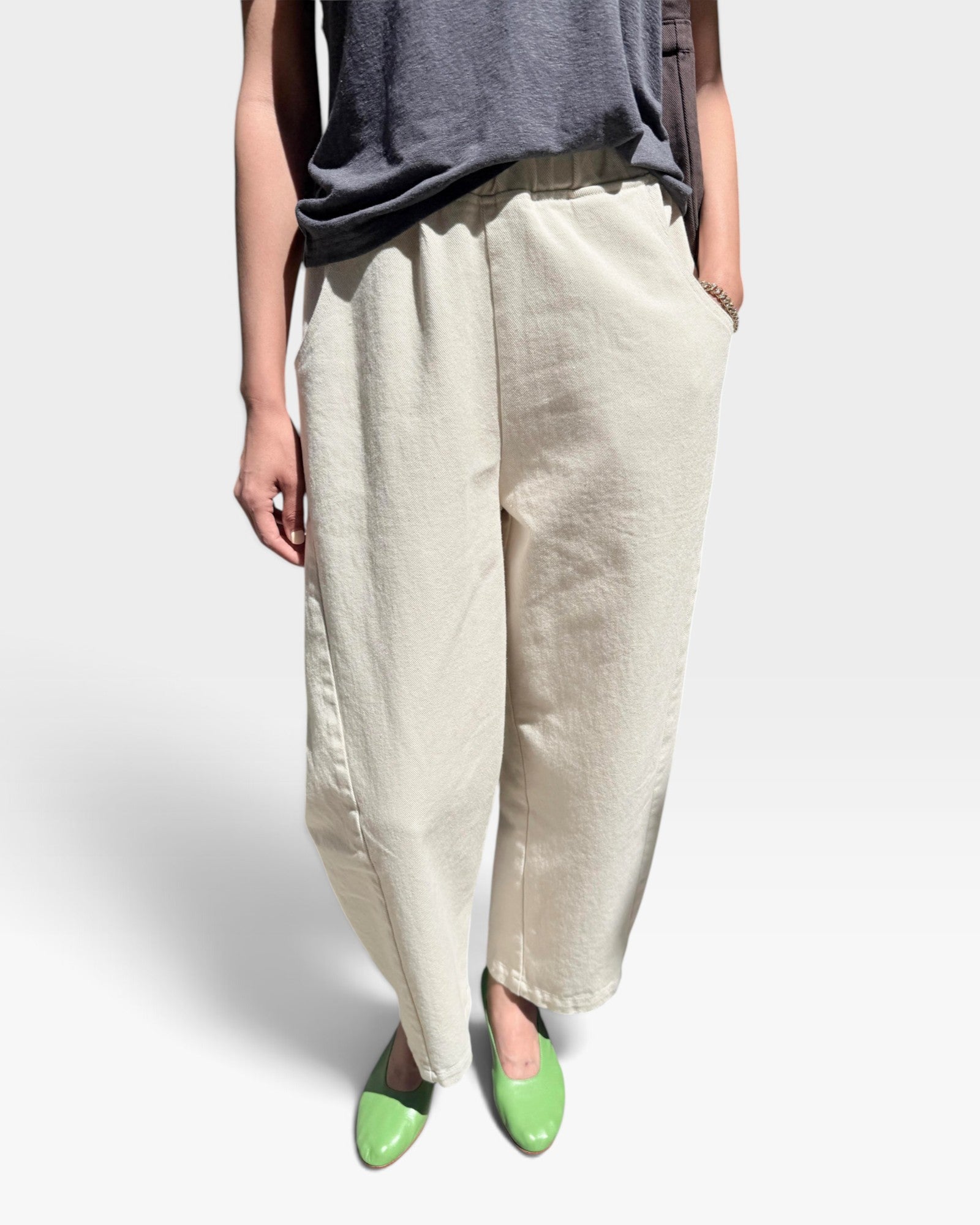JONES + CO Arc pants in naturel heavy-weight canvas with an elastic high waist, curved leg, and side panel details.