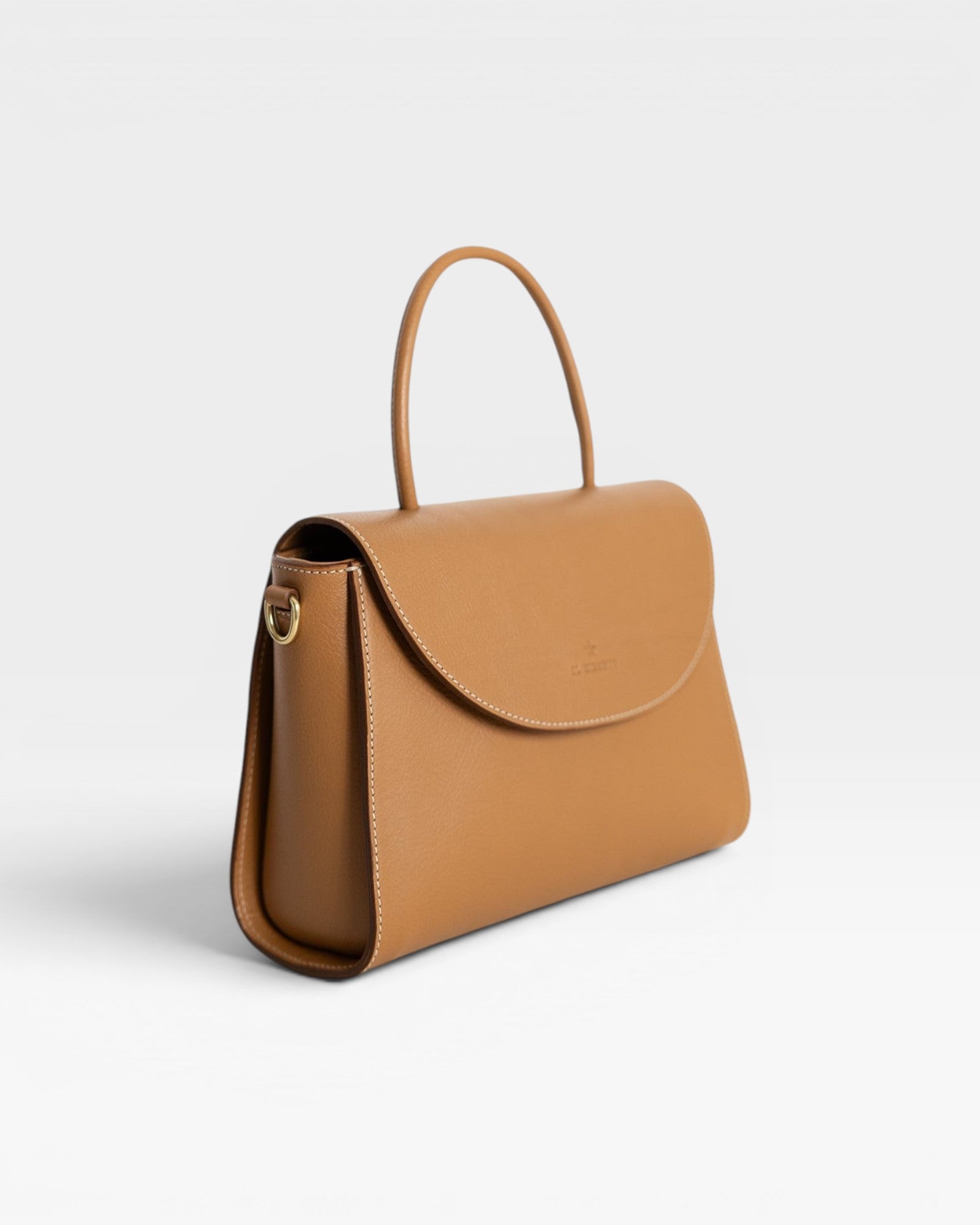 JONES + CO Archive 1978 Linea Top Handle Bag in Gianduia brown vegetable-tanned leather with rounded flap and knotted handle.