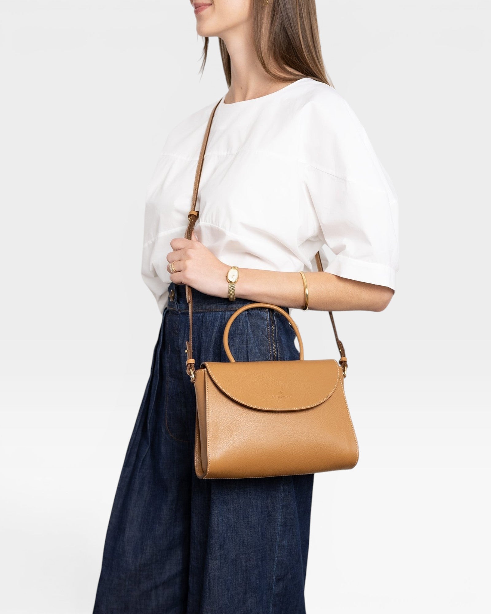 JONES + CO Archive 1978 Linea top handle bag in gianduia brown vegetable-tanned leather with rounded flap and adjustable strap.