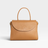 JONES + CO Archive 1978 Linea Top Handle Bag in Gianduia brown vegetable-tanned leather with rounded flap and white stitching.
