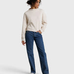 JONES + CO Arden mock neck sweatshirt in sugar cream French terry fabric worn with blue jeans by a female model