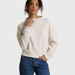 Model wearing JONES + CO Arden mock neck sweatshirt in sugar cream French terry with a boxy fit and long sleeves