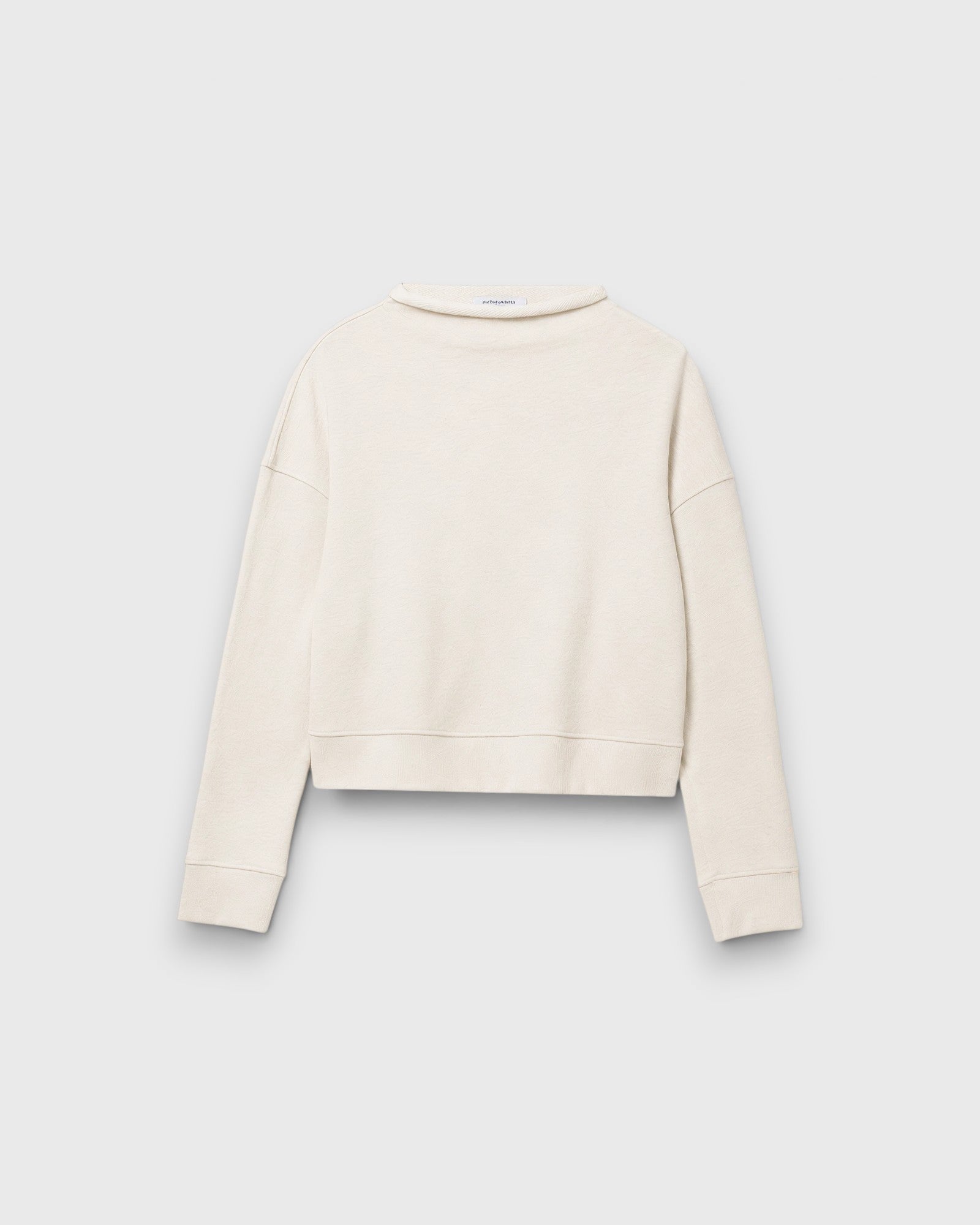 JONES + CO Arden mock neck sweatshirt in sugar cream French terry fabric with a boxy fit and long sleeves.
