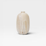 JONES + CO handthrown ceramic vase with ash glaze in natural beige and white drip effect.