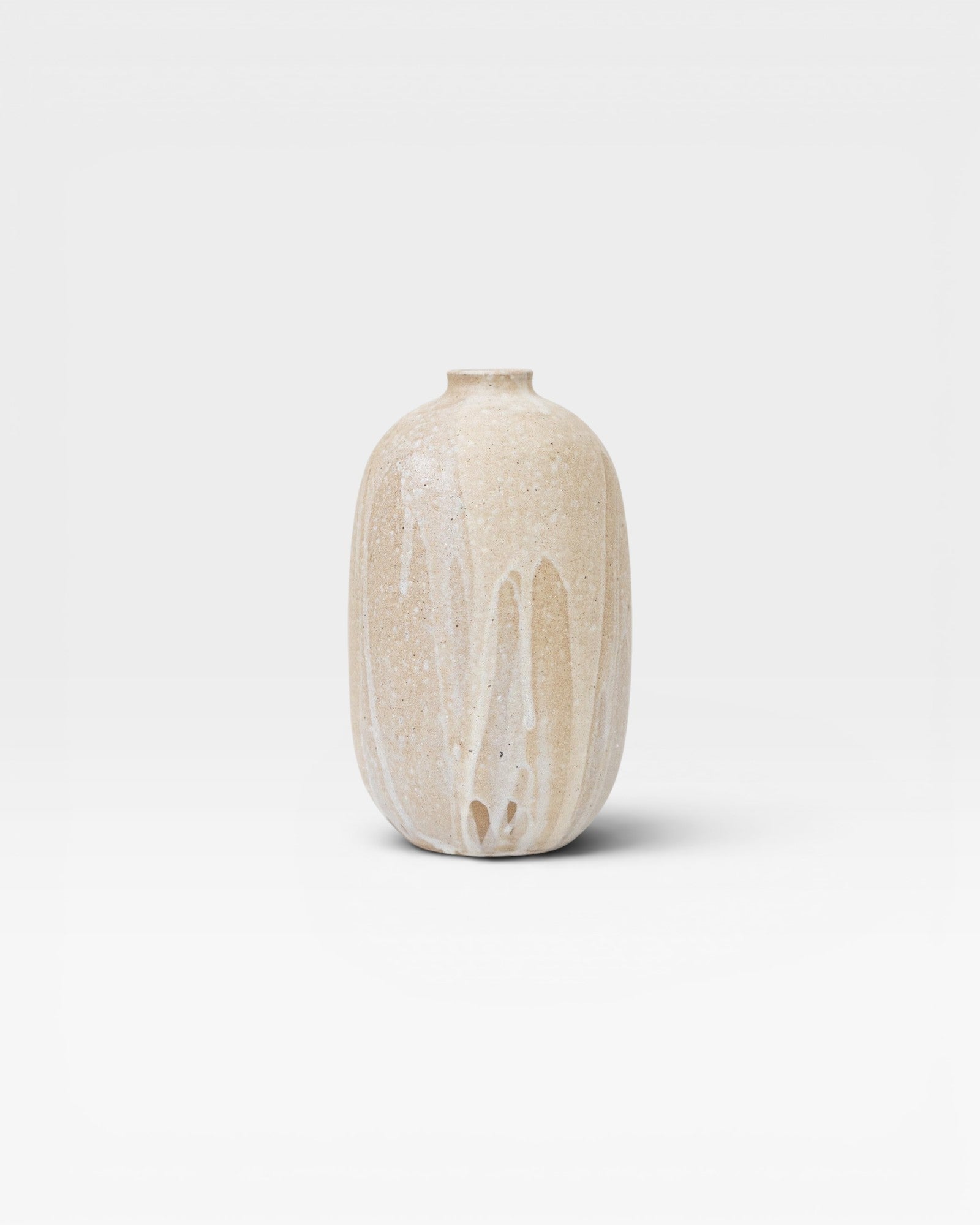 JONES + CO handthrown ceramic vase with ash glaze in natural beige and white drip effect.