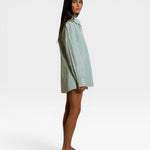JONES + CO Avalon teal blue and sugar stripe cotton poplin oversized button-down shirt worn by a model, side view.