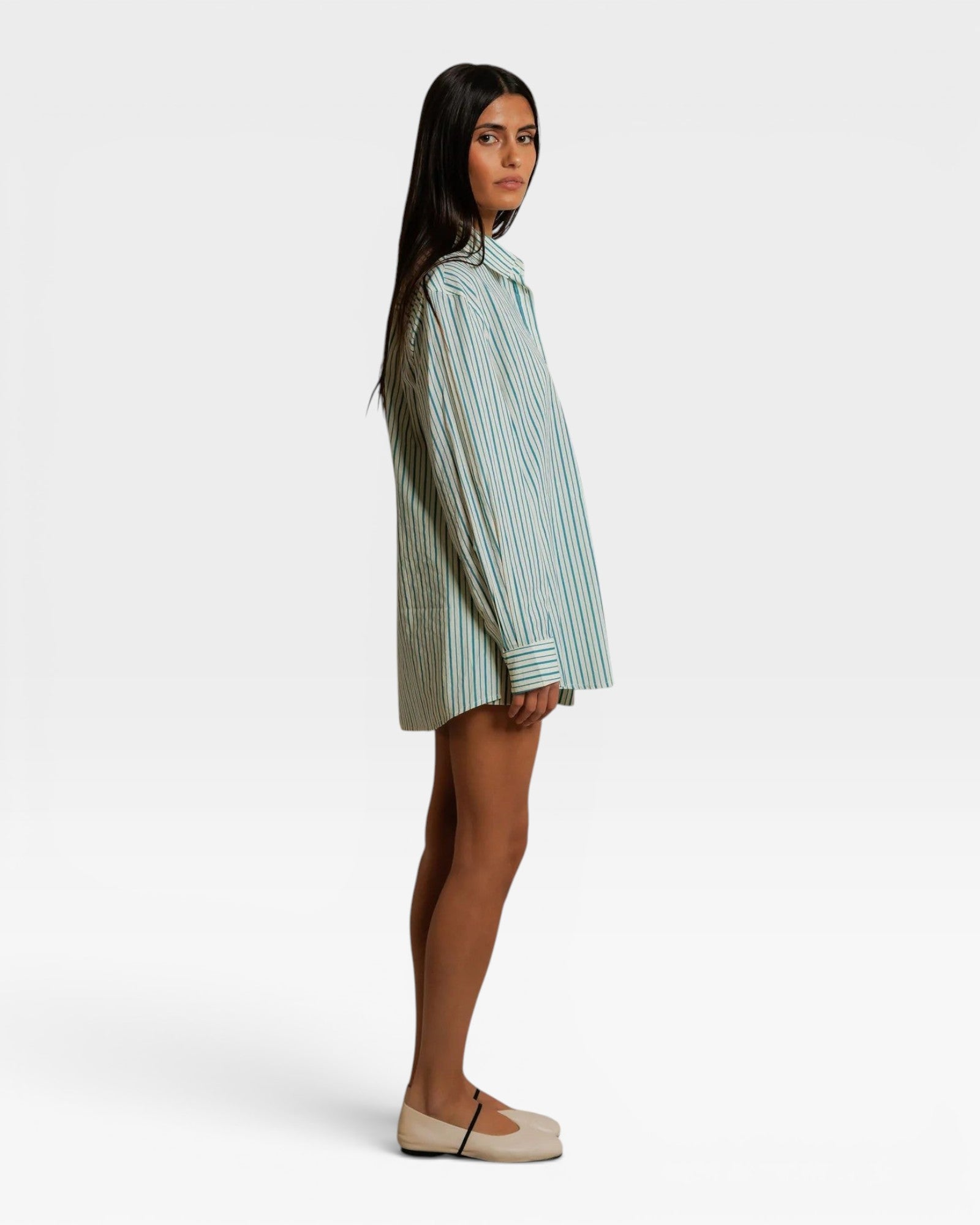 JONES + CO Avalon teal blue and sugar stripe cotton poplin oversized button-down shirt worn by a model, side view.