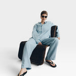 JONES + CO baby blue oversized linen shirt and matching pants, worn by a woman with short hair and sunglasses.