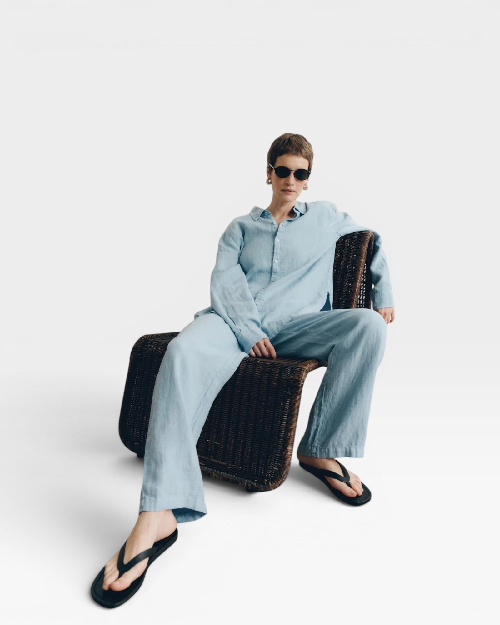 JONES + CO baby blue oversized linen shirt and matching pants, worn by a woman with short hair and sunglasses.