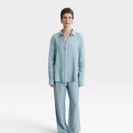 JONES + CO baby blue oversized linen button-down shirt with matching wide-leg pants.
