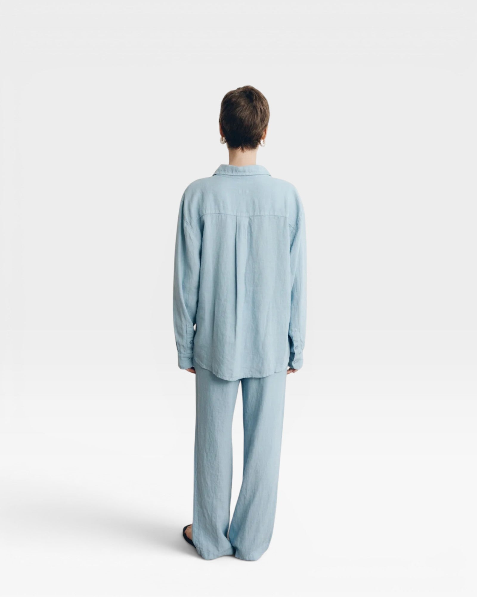 JONES + CO baby blue oversized linen shirt and matching wide-leg pants on a model.