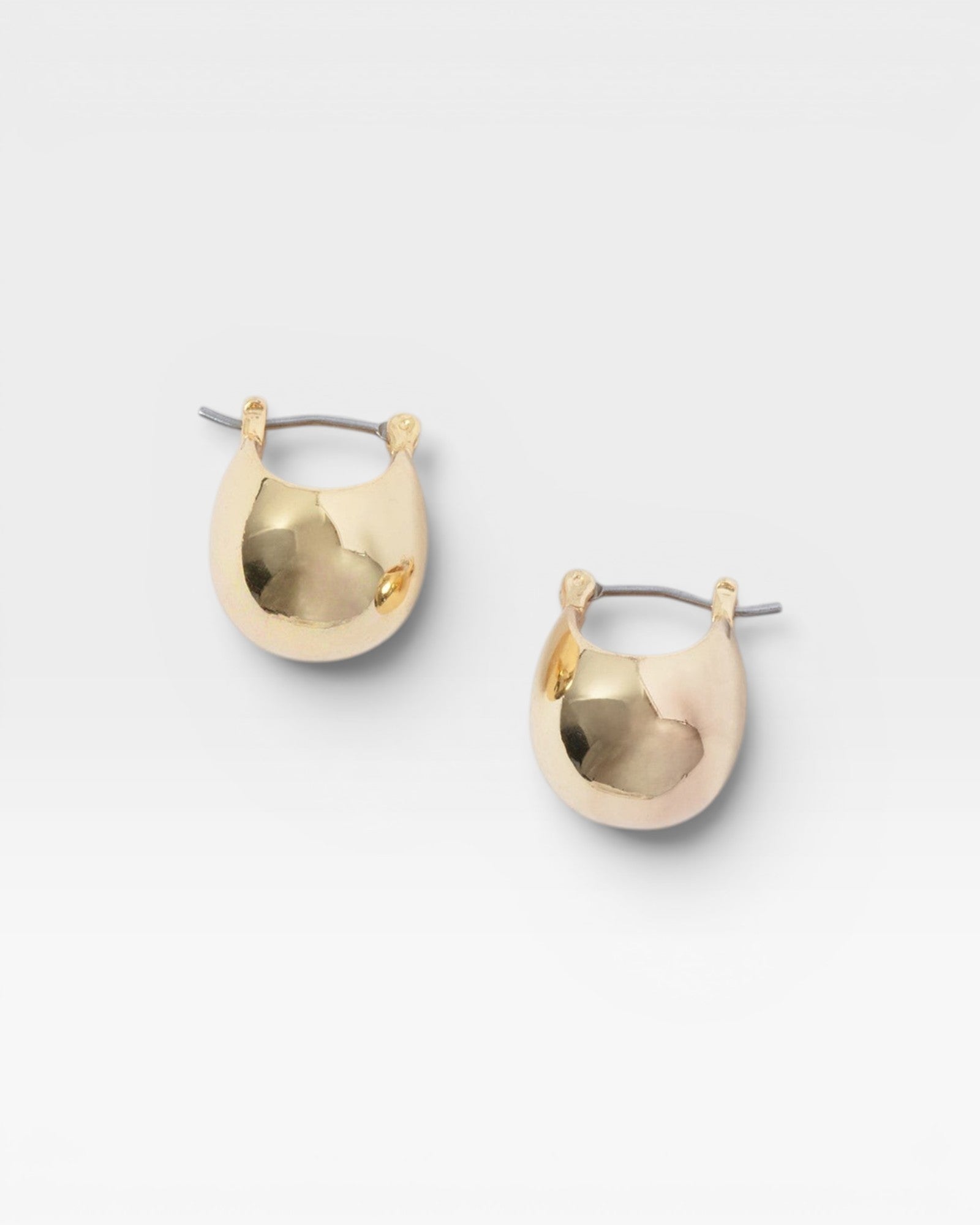 JONES + CO Baby Keel Hoop mini hollow oblong gold hoop earrings with hinged fastening.