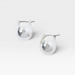 JONES + CO Baby Keel Hoop mini hollow oblong silver hoop earrings with hinged fastening.