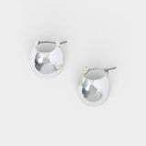 JONES + CO Baby Keel Hoop mini hollow oblong silver hoop earrings with hinged fastening.