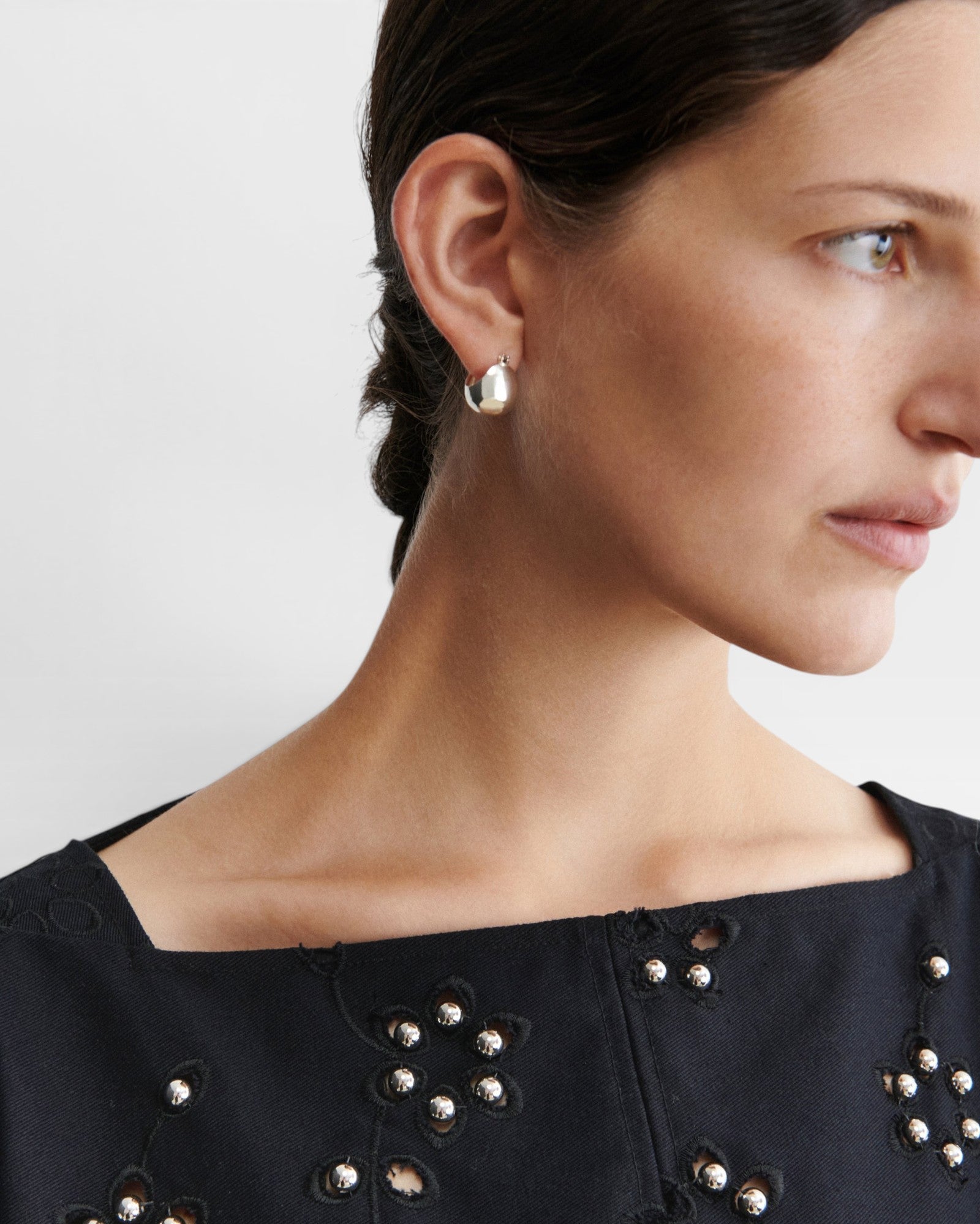 JONES + CO Baby Keel Hoop mini hollow oblong silver hoop earrings with hinged fastening.