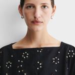 JONES + CO Baby Keel Hoop mini hollow oblong silver hoop earrings with hinged fastening.