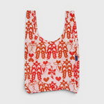 JONES + CO Baggu reusable grocery bag in pink nylon with a red cowgirl, heart, and lasso print pattern.