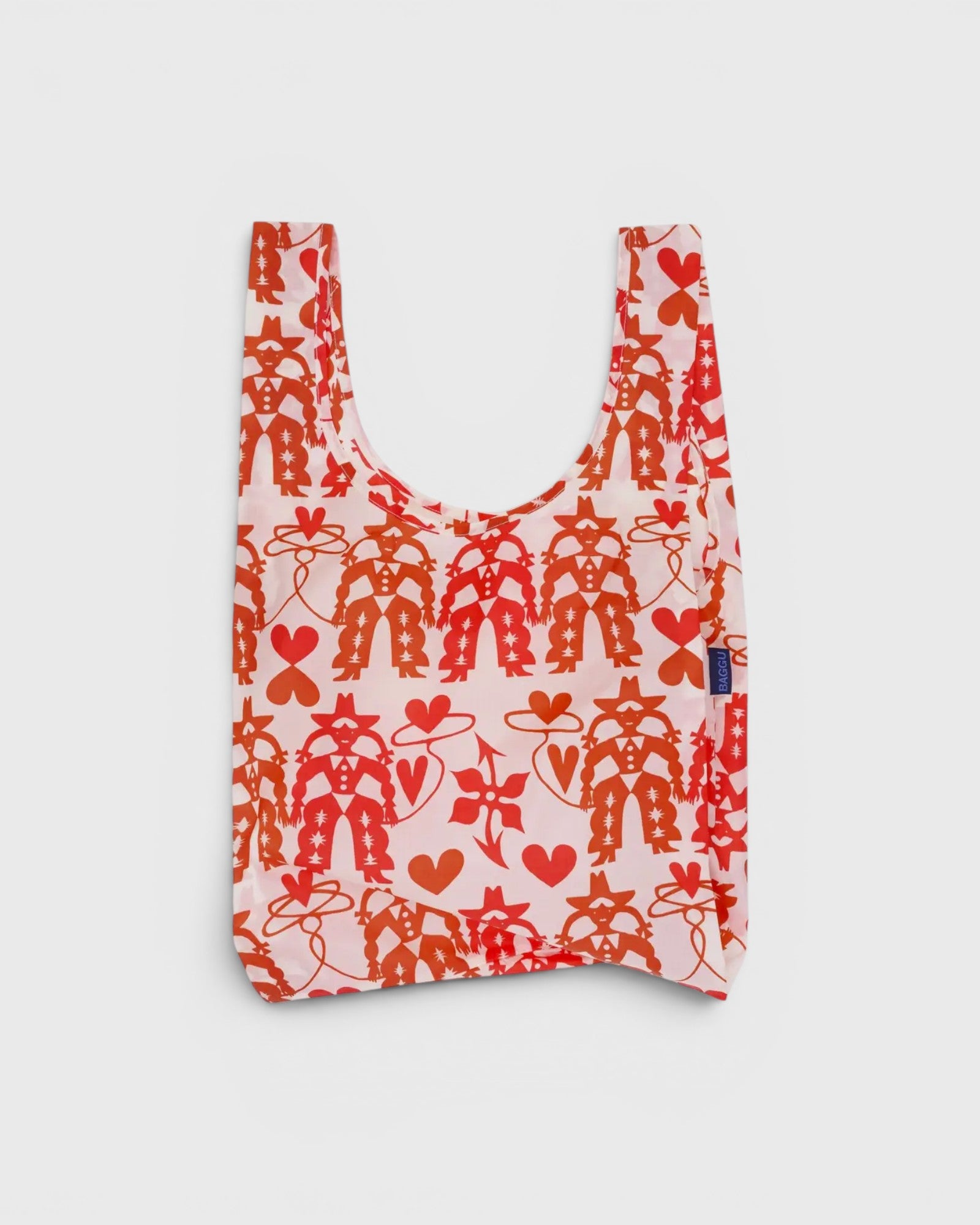 JONES + CO Baggu reusable grocery bag in pink nylon with a red cowgirl, heart, and lasso print pattern.